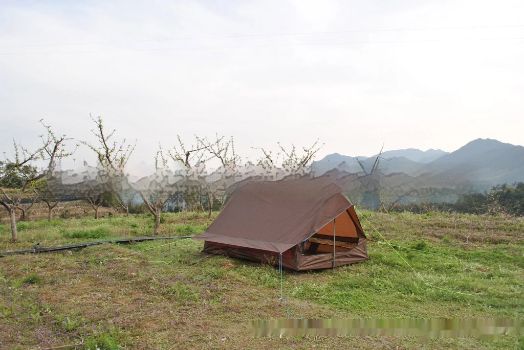 Brown and white pole-free A-line cabin tent for 2-3 people shown pitched with hiking poles.