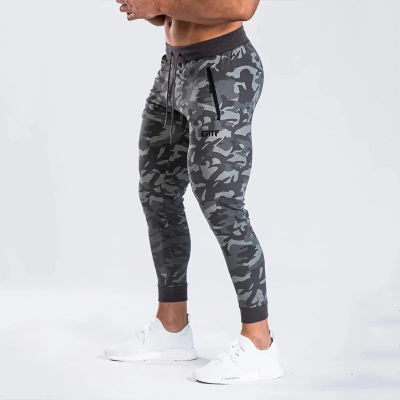 Men's camouflage quick dry jogging trousers in slim fit style from front view on plain background