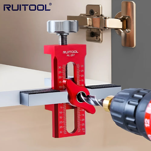 Aluminium alloy cabinet door installation aid tool for woodworking projects on a workbench.