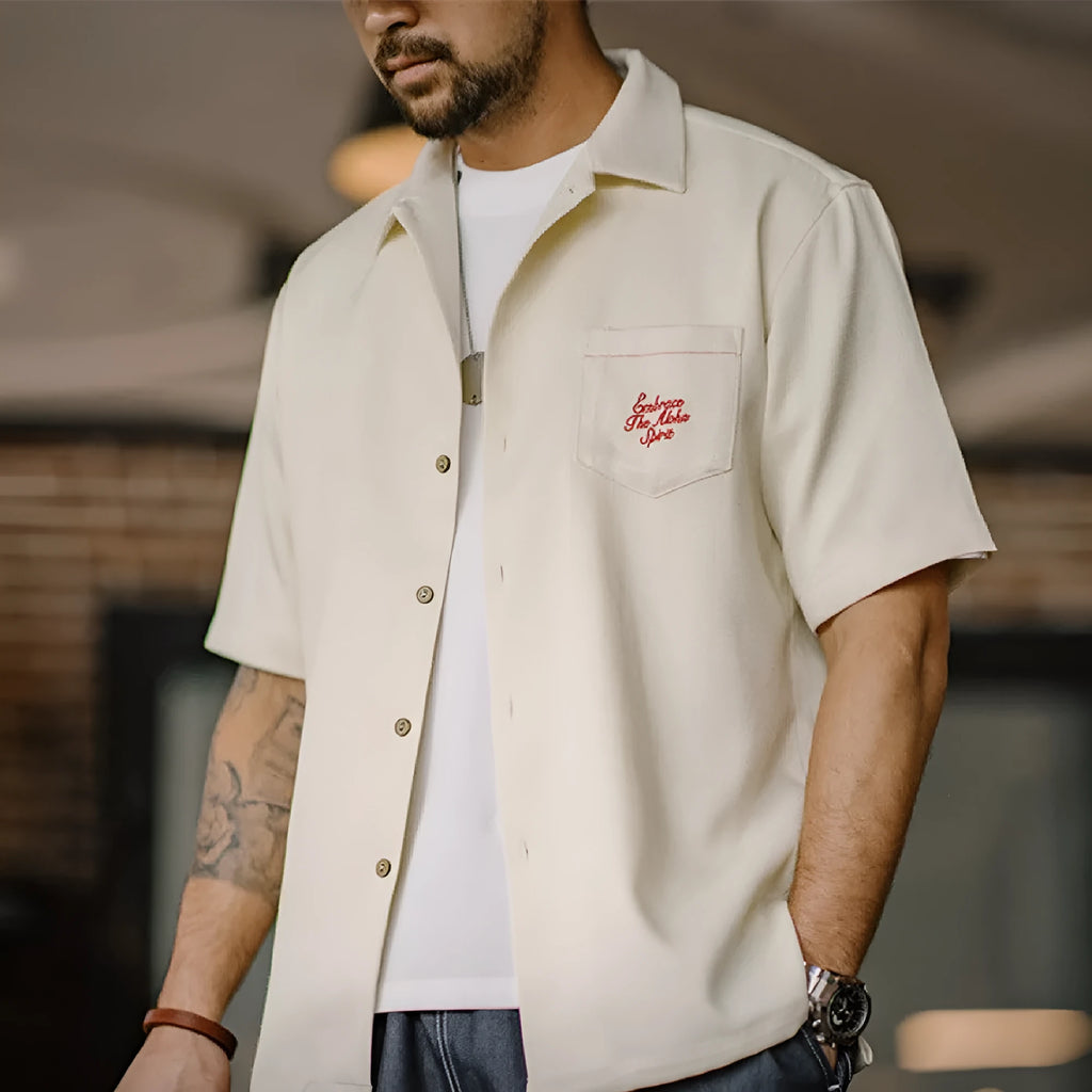 Men's light apricot shirt with bamboo leaf pattern and a Cuban collar on a short sleeve design.