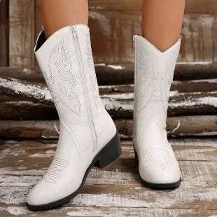 Women's black mid-calf Martin boots with chunky heel, pointed toe, and hollow out design detail on a white background.