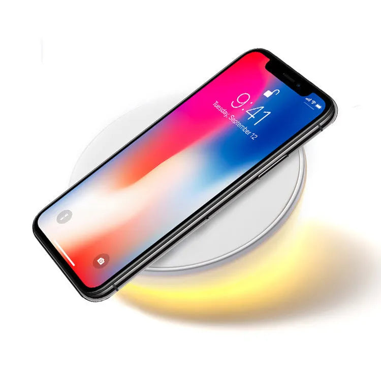 White 10W wireless phone charger with digital clock display and control buttons.