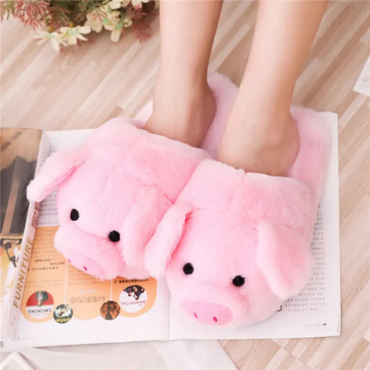 Pink pig-shaped plush floor slippers for indoor use.
