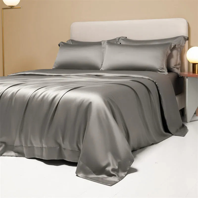 Luxury Lenzing Tencel bedding set in Aurora Blue on a bed, showing quilt cover, sheet, and two pillowcases.
