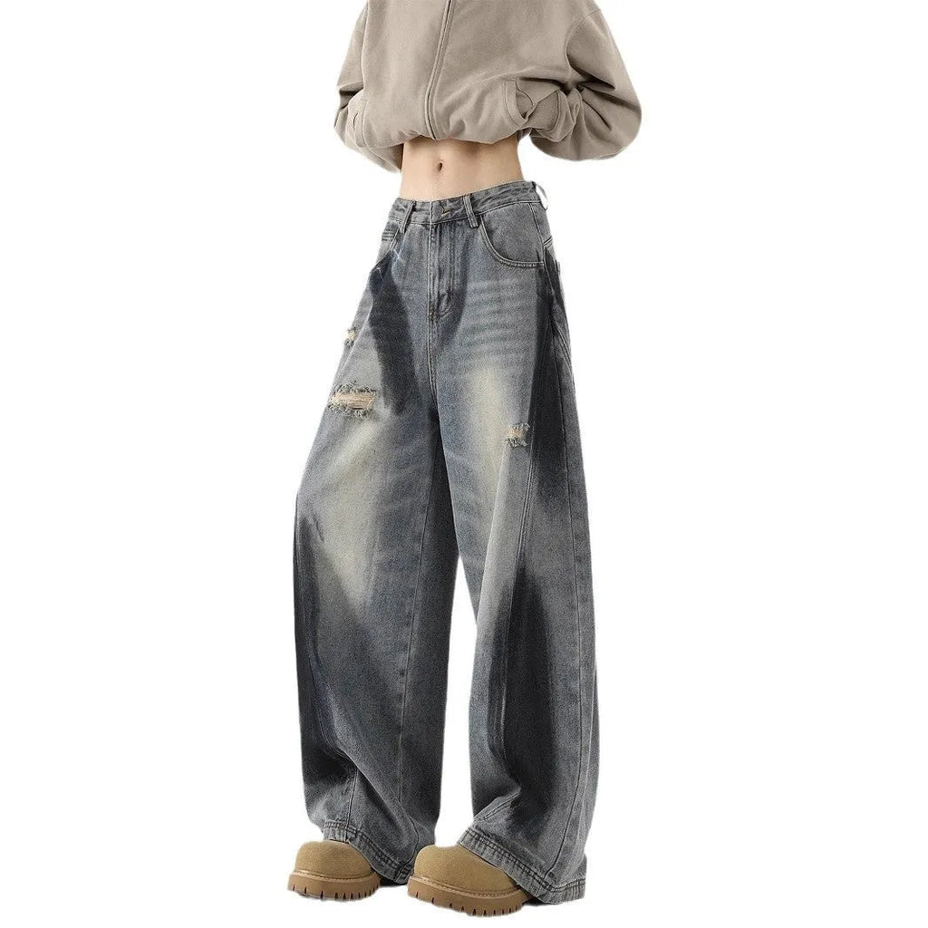 Men's blue ripped jeans with splash-ink design detail showing cotton fabric with micro elasticity