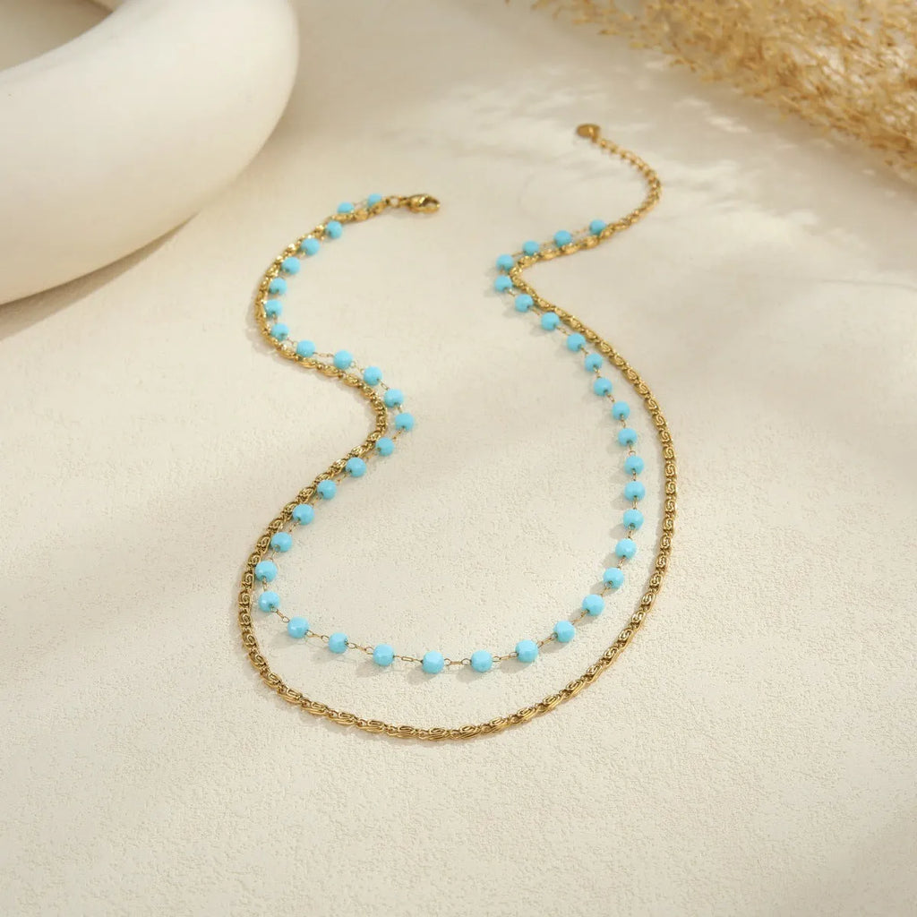 Stainless steel zircon necklace clavicle chain with beaded blue bracelet set geometric pendant on white background