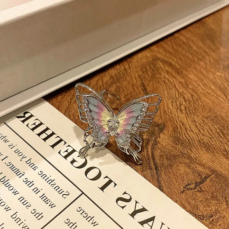 Creative butterfly design women's ring in copper with oil drip finish, showing an open loop style.
