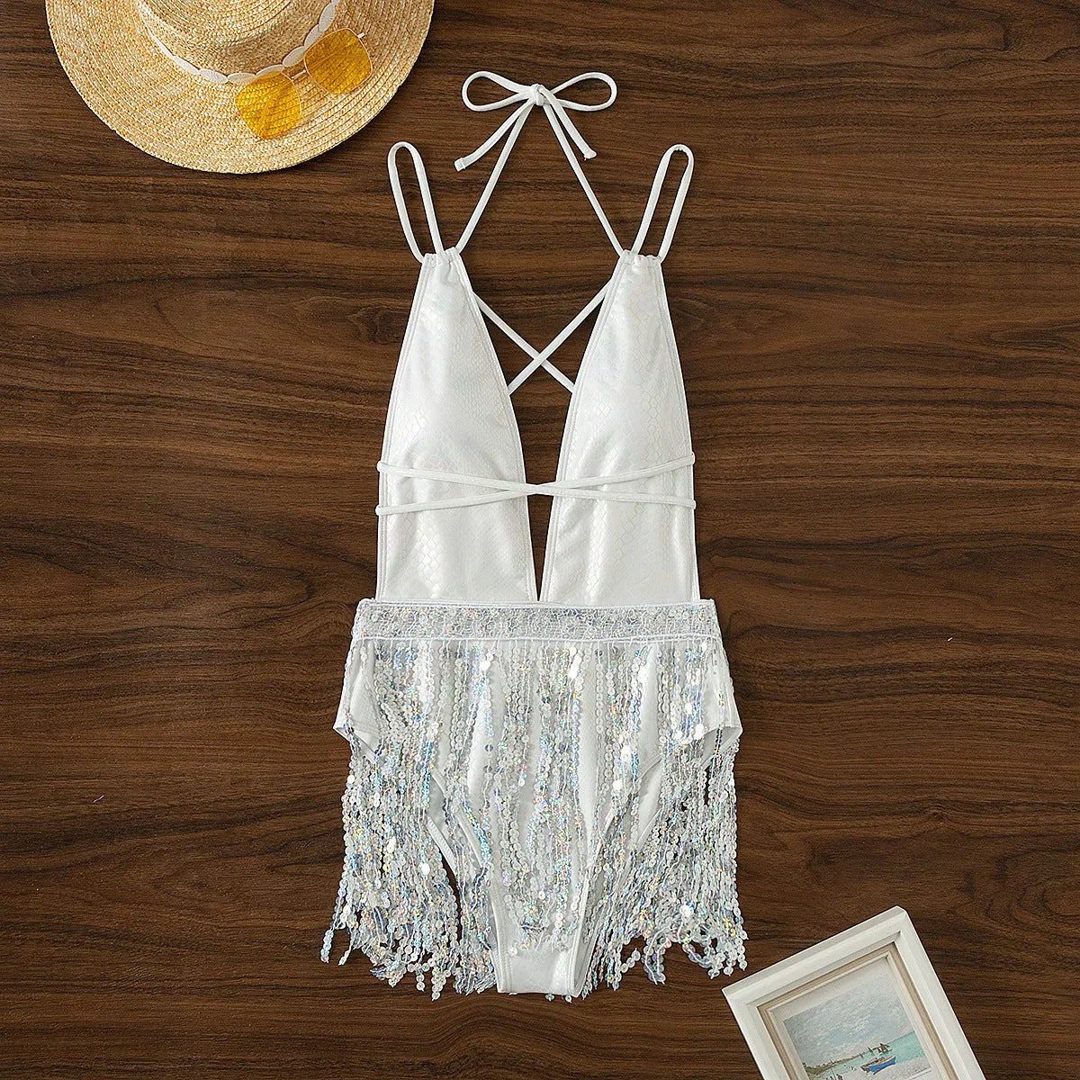 White women's one-piece swimsuit with deep V-neck and tassel details
