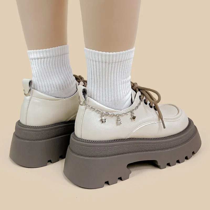 White platform Mary Jane shoes with a chunky block heel and front lace-up detail.