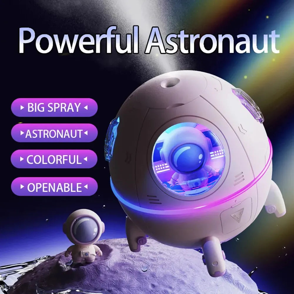 Light purple astronaut-shaped USB desktop humidifier with colourful LED light on a desk.