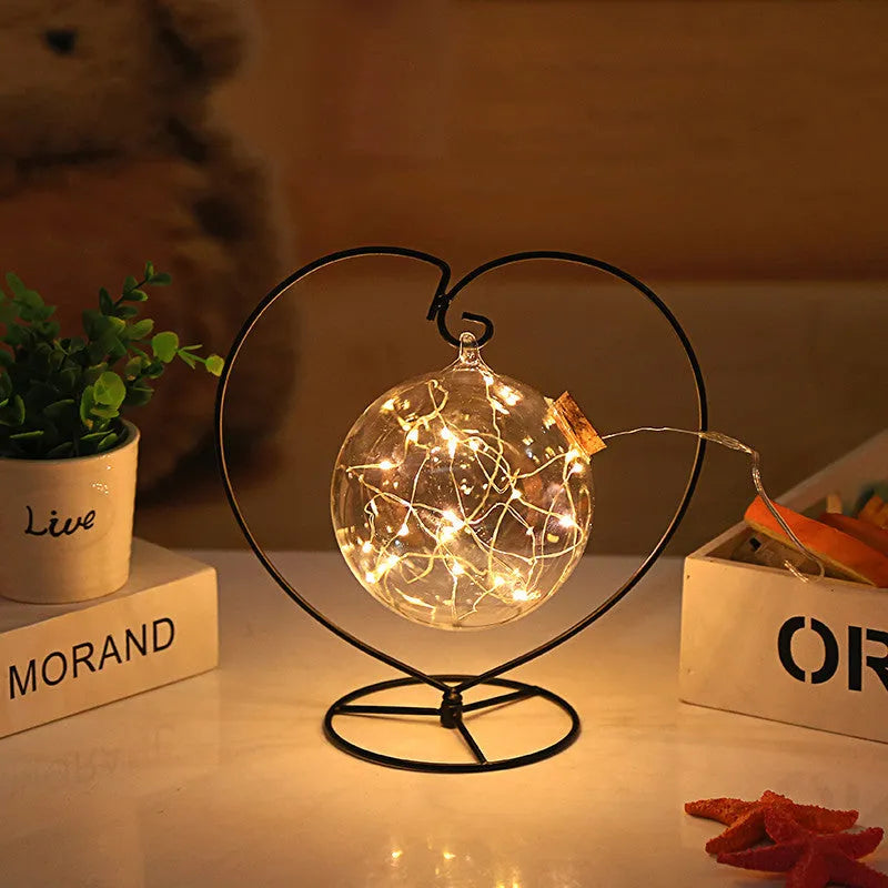 Round glass wish bottle with cork, 12 cm diameter, containing a warm white LED light strand with 20 lamp beads and folded paper stars