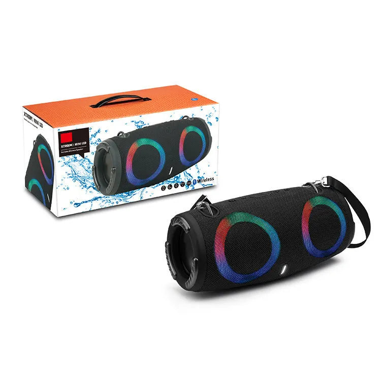 War Drum portable Bluetooth speaker with RGB lights in camouflage finish, showing carry strap and control buttons.
