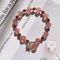 Handmade women's bracelet with Hetian jade and strawberry quartz crystals in peach blossom design