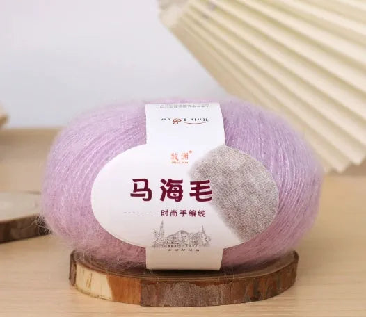 Ball of mohair yarn for DIY scarf knitting in one of 34 colours, including white, pink, blue, and green.