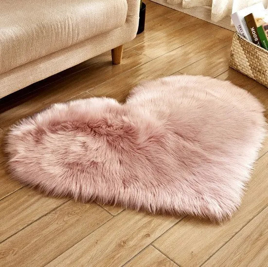 Heart-shaped plush carpet in multiple colours showing wool-like texture with 5-6 cm pile length