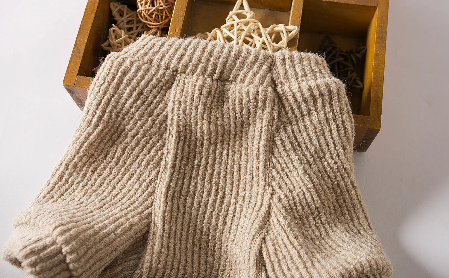 Brown knitted pullover sweater on a small dog, showing casual design and soft fabric.