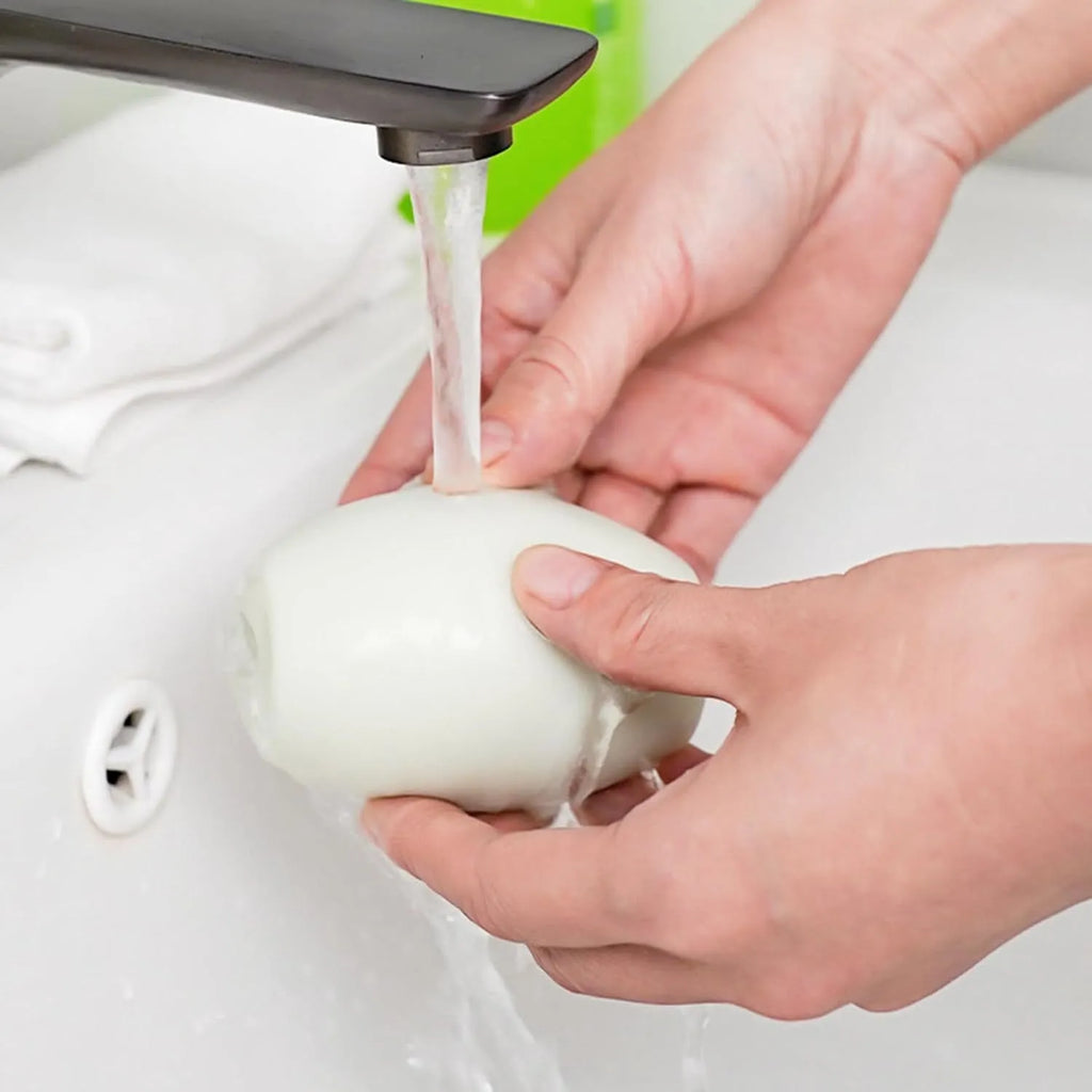 Green and white washable reusable gel lint roller ball for pet hair removal.