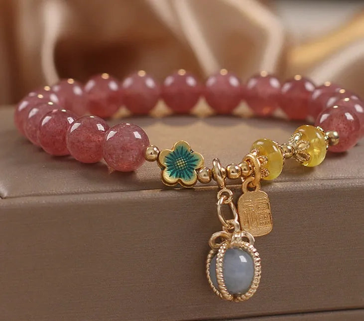 Red adjustable bracelet with strawberry quartz beads, alloy charm and rhinestone detailing
