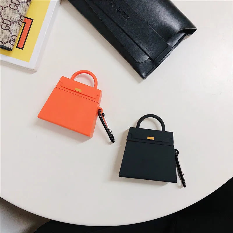 Silicone anti-drop earphone case for Apple AirPods 1 and 2 in black or orange, clamshell bag shape.