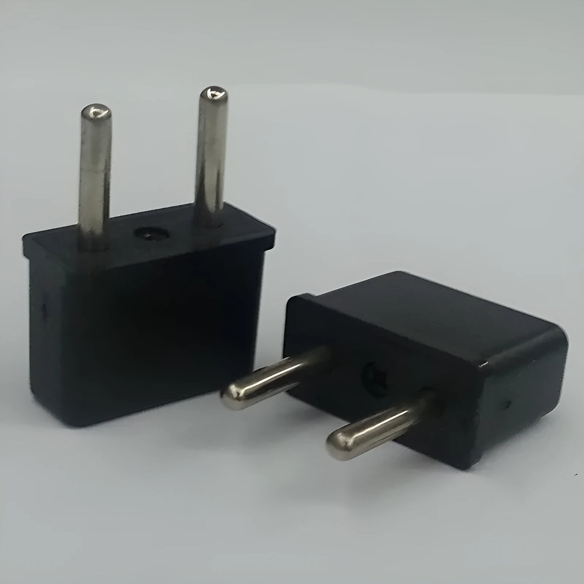 Plastic American to European plug adapter with 2 holes, copper conductors, 10A rating