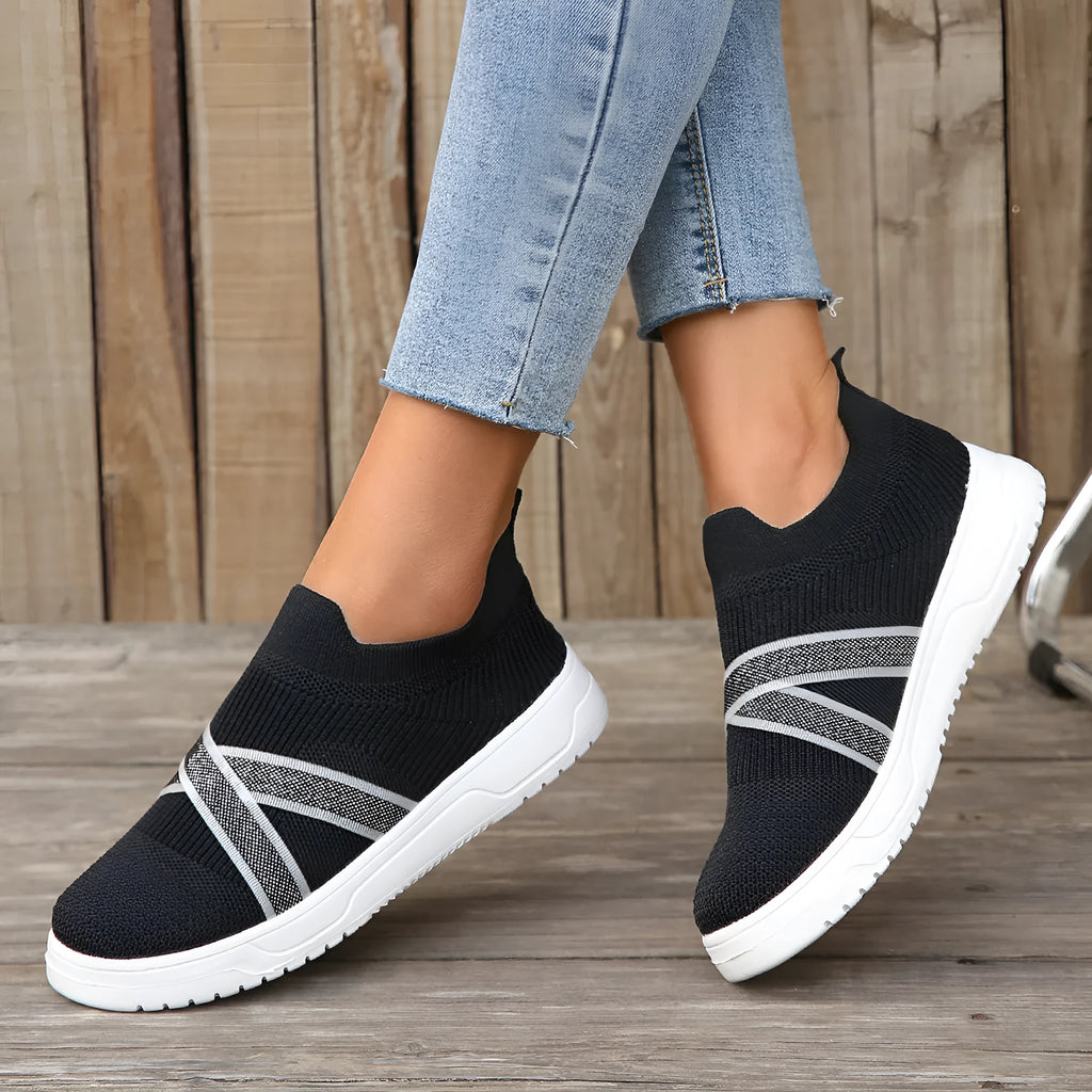 Black women's flyknit mesh shoes with flat rubber sole and tassel detail