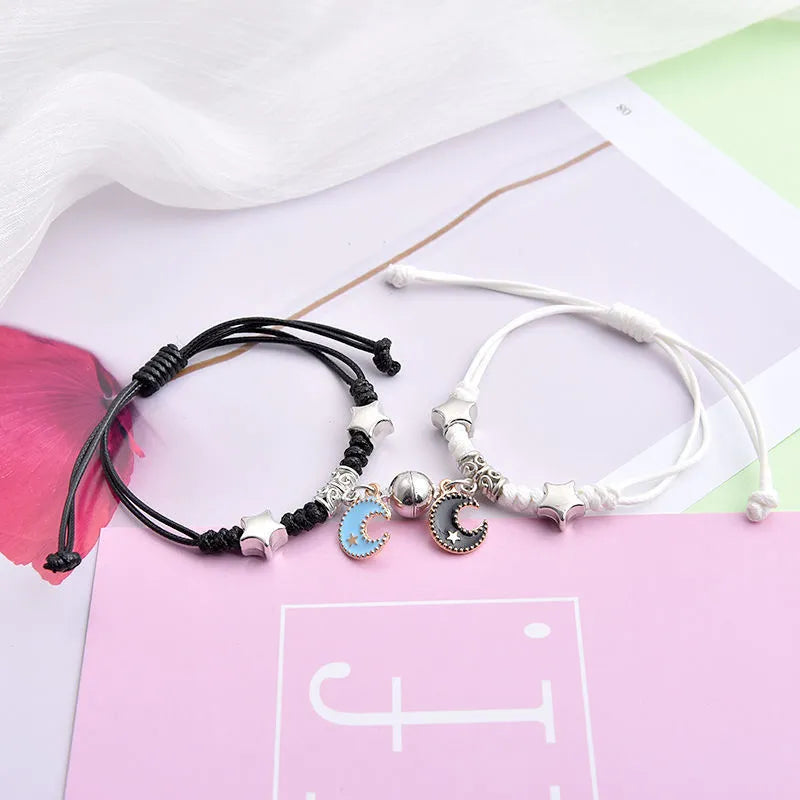 Magnet suction couple bracelets with alloy construction and various pendant designs including crowns and hearts