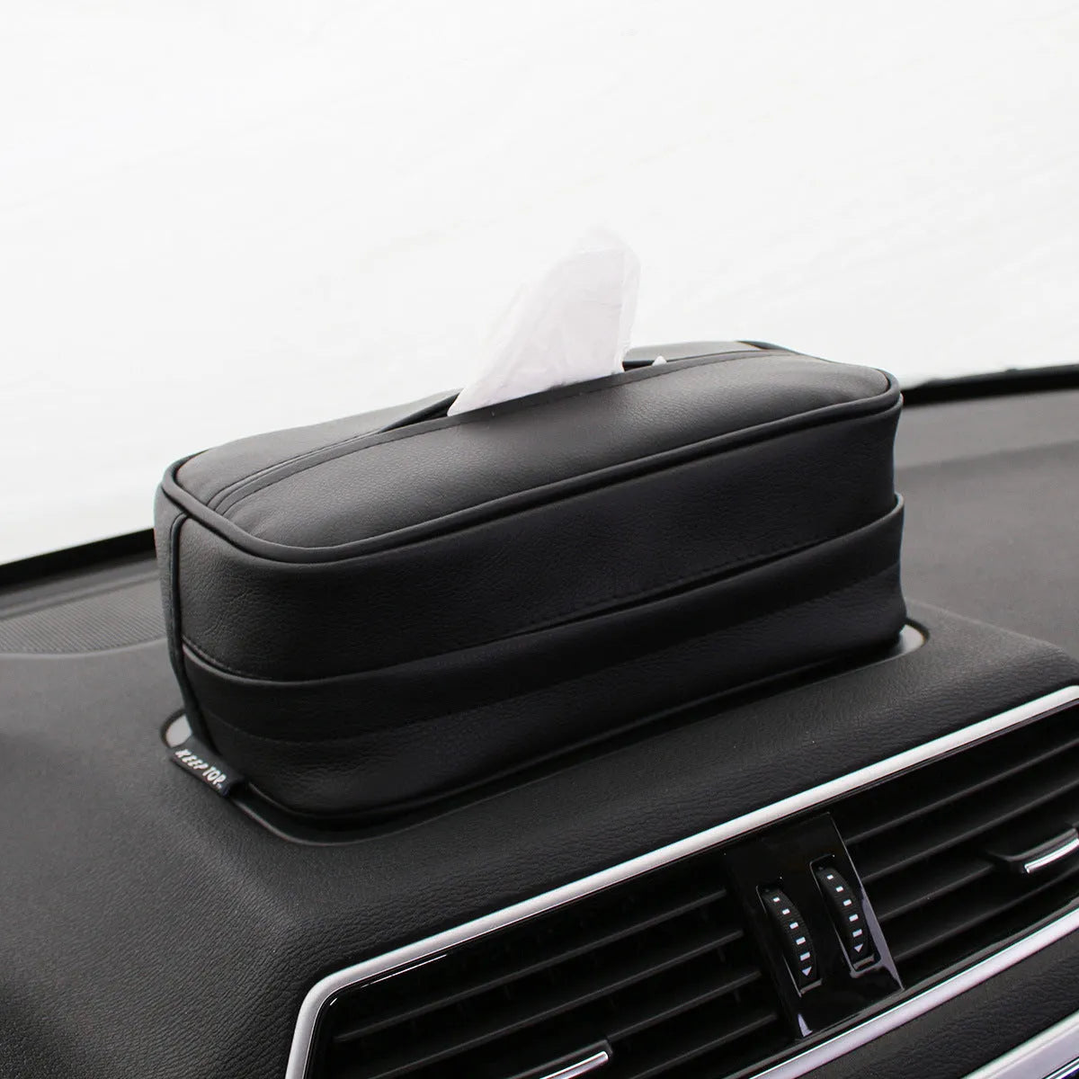 Black PU leather car hanging organiser bag with paper insert for storing documents.