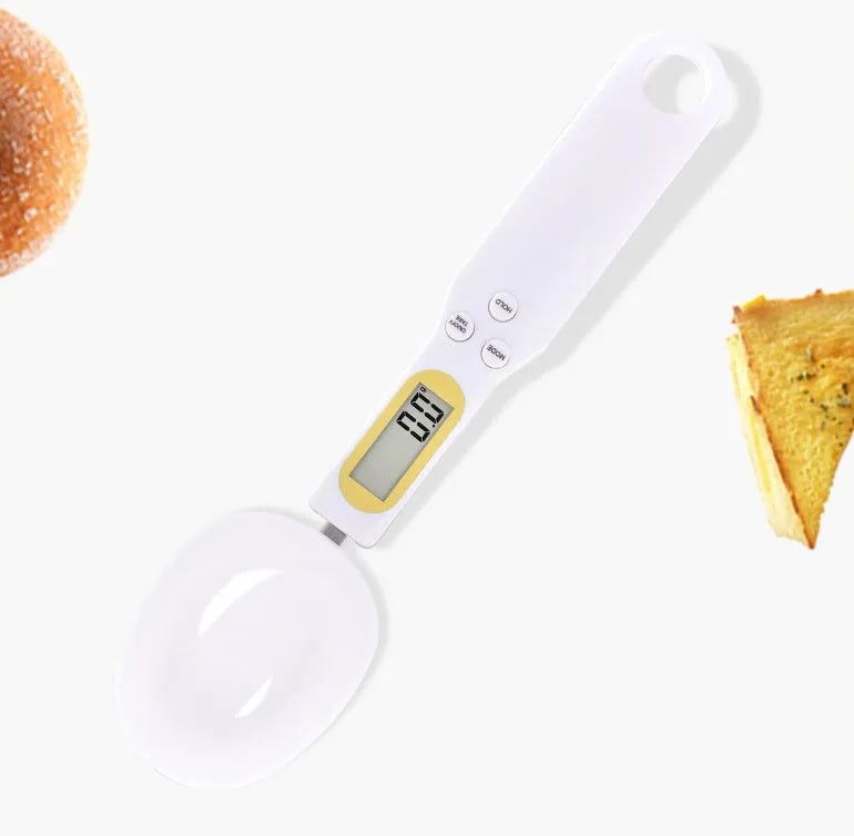 Black electronic digital scale with integrated measuring spoon showing weight display.