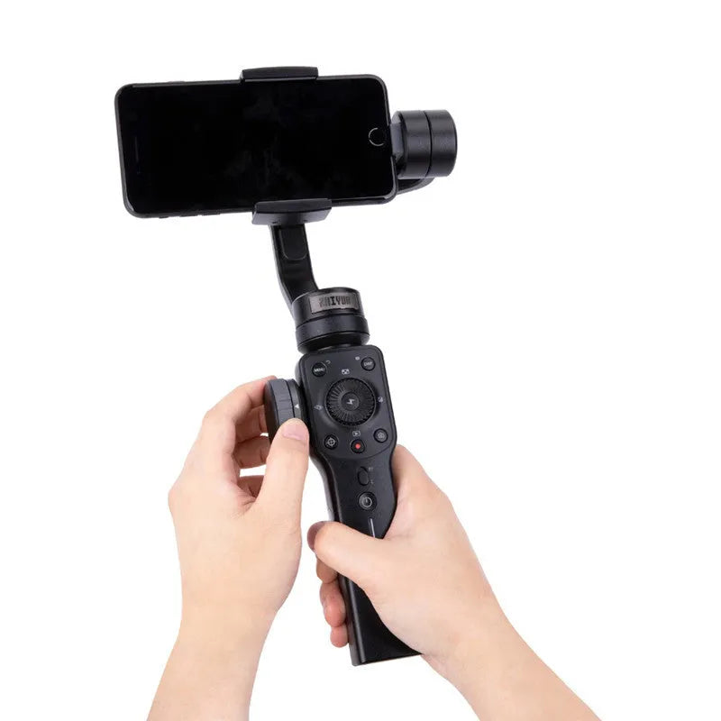 Black handheld smartphone gimbal stabilizer on a table