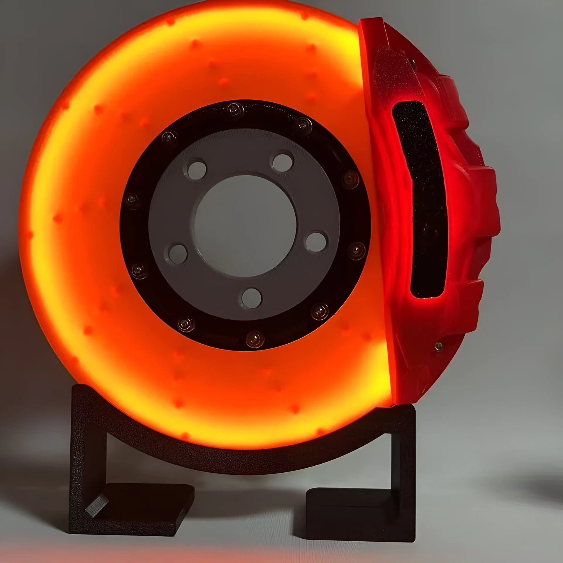 Brake disc themed LED desktop night light in blue caliper colour with touch control