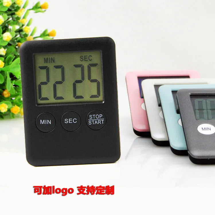 Black or white plastic digital kitchen timer with LCD display and magnetic back.