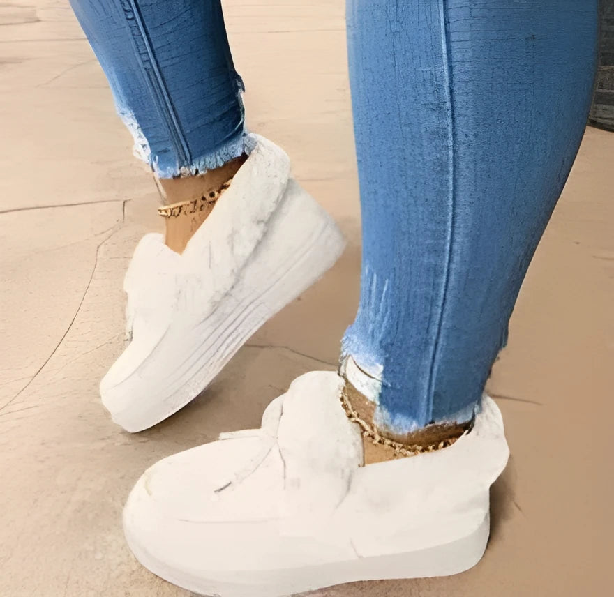 Women's white cotton slip-on house shoes with a round toe and non-slip rubber sole.