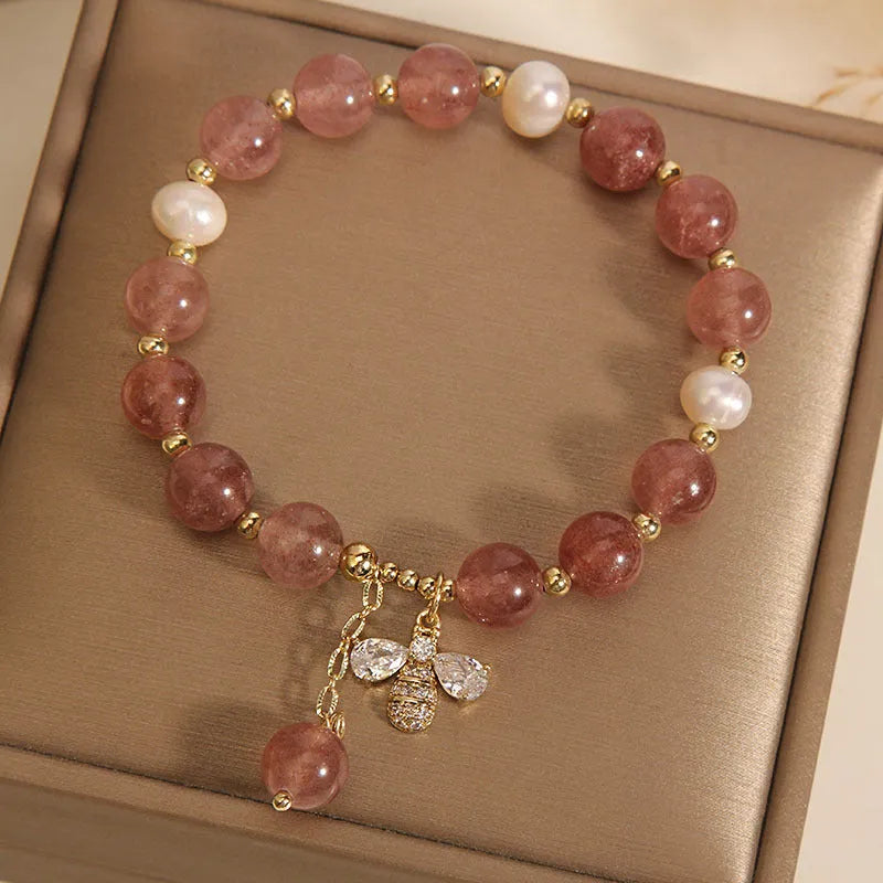 Women's bracelet with pink strawberry quartz stones, white freshwater pearls, and sparkling zircon on an alloy chain.