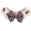 A red houndstooth wool knitted pet collar laid flat showing its length and texture.