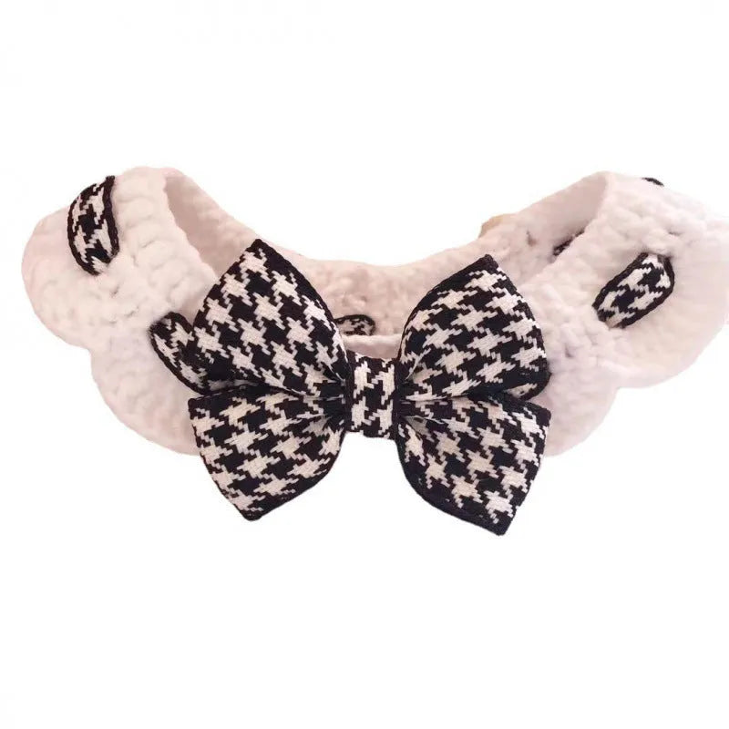 A red houndstooth wool knitted pet collar laid flat showing its length and texture.