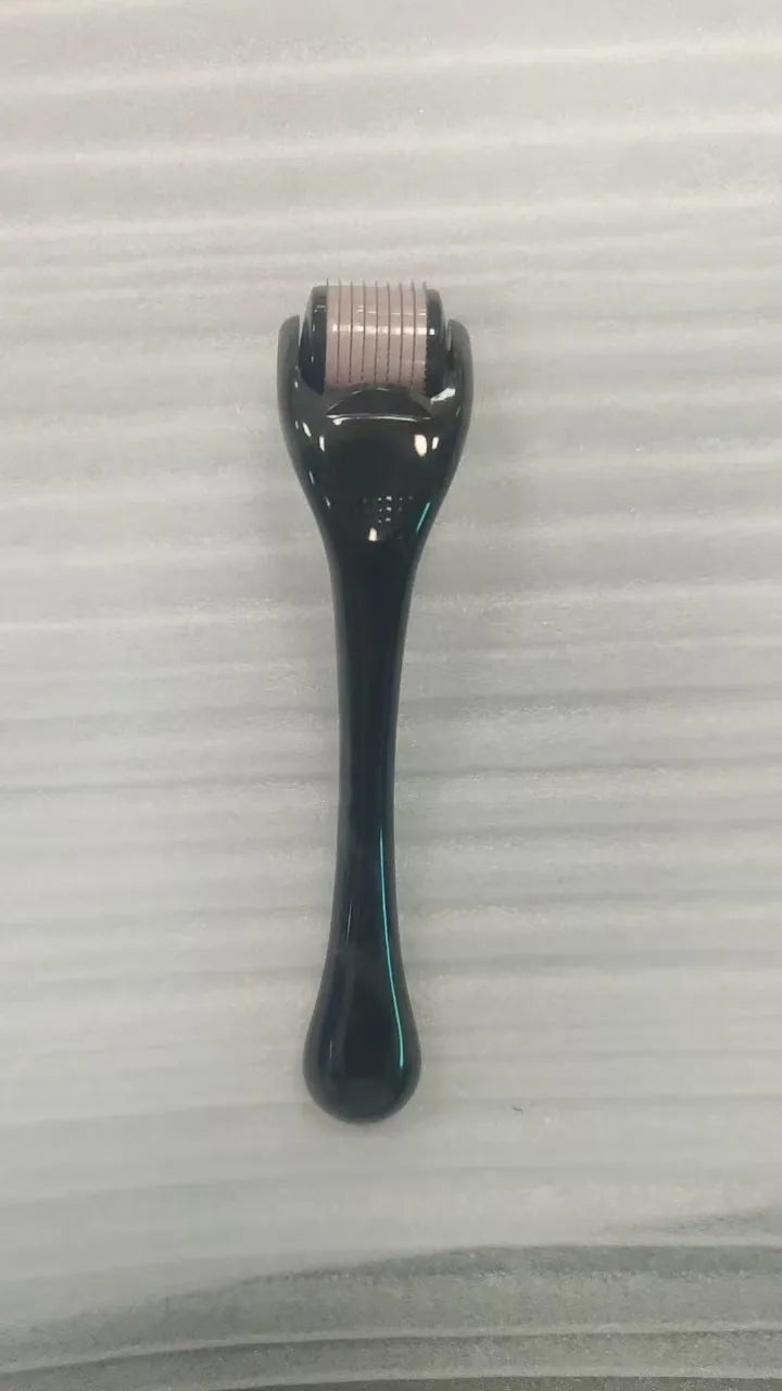 540 micro needle roller tool with black handle and coloured wheel on a white background.