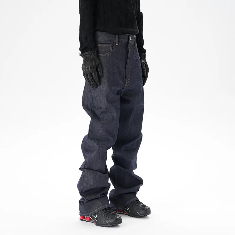 Man wearing dark blue loose fit straight leg denim jeans.