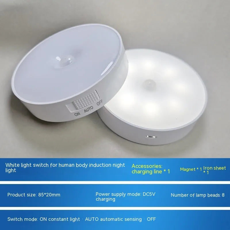 Compact round beige motion sensor LED night light with USB charging cable on a wooden surface