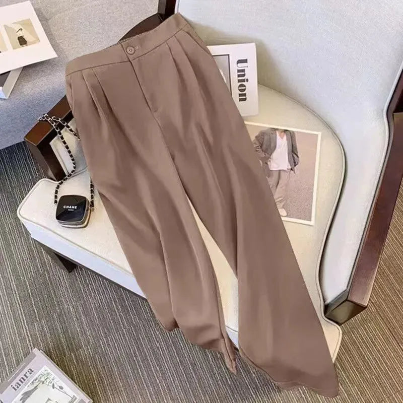 Women's loose fit polyester blouse in black on a hanger, showing regular sleeves and a front view.