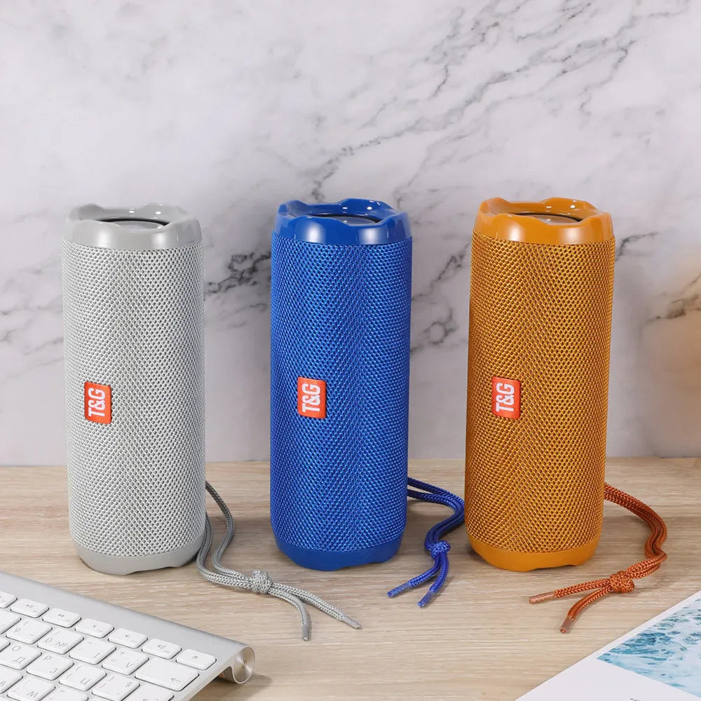 Fabric-covered portable Bluetooth speaker showing the integrated card holder slot, displayed in the camouflage colour variant.