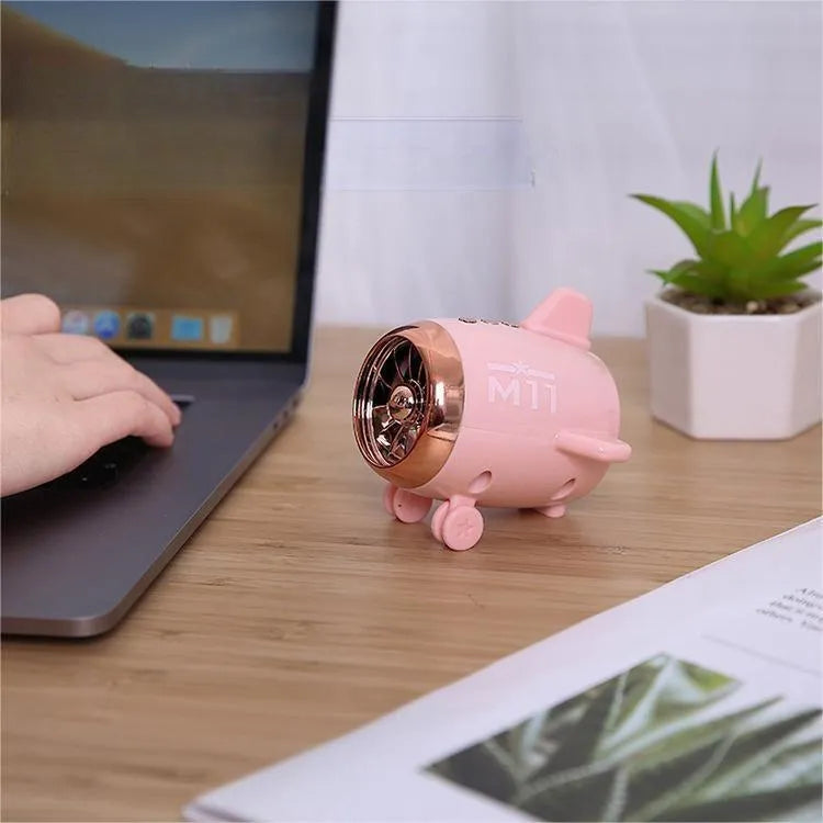Mini wireless Bluetooth speaker in various colours showing compact 85mm × 75mm × 70mm design