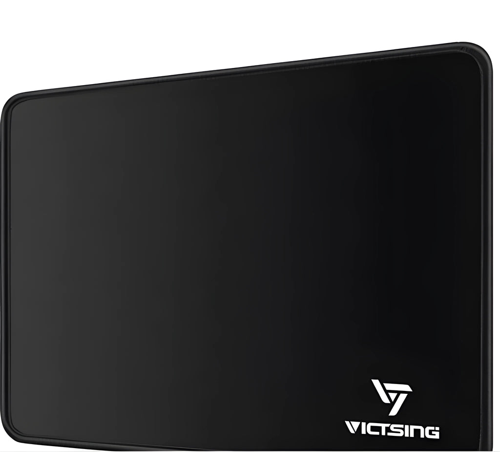 Black thickened rubber mouse pad on a desk, showing its textured surface and substantial 5mm profile.