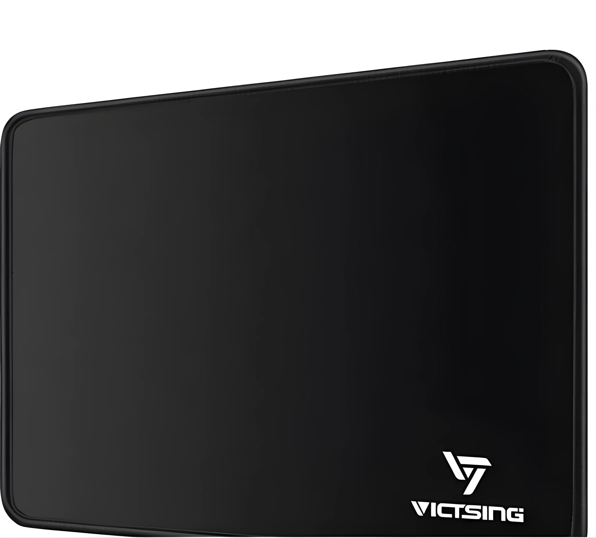 Black thickened rubber mouse pad on a desk, showing its textured surface and substantial 5mm profile.