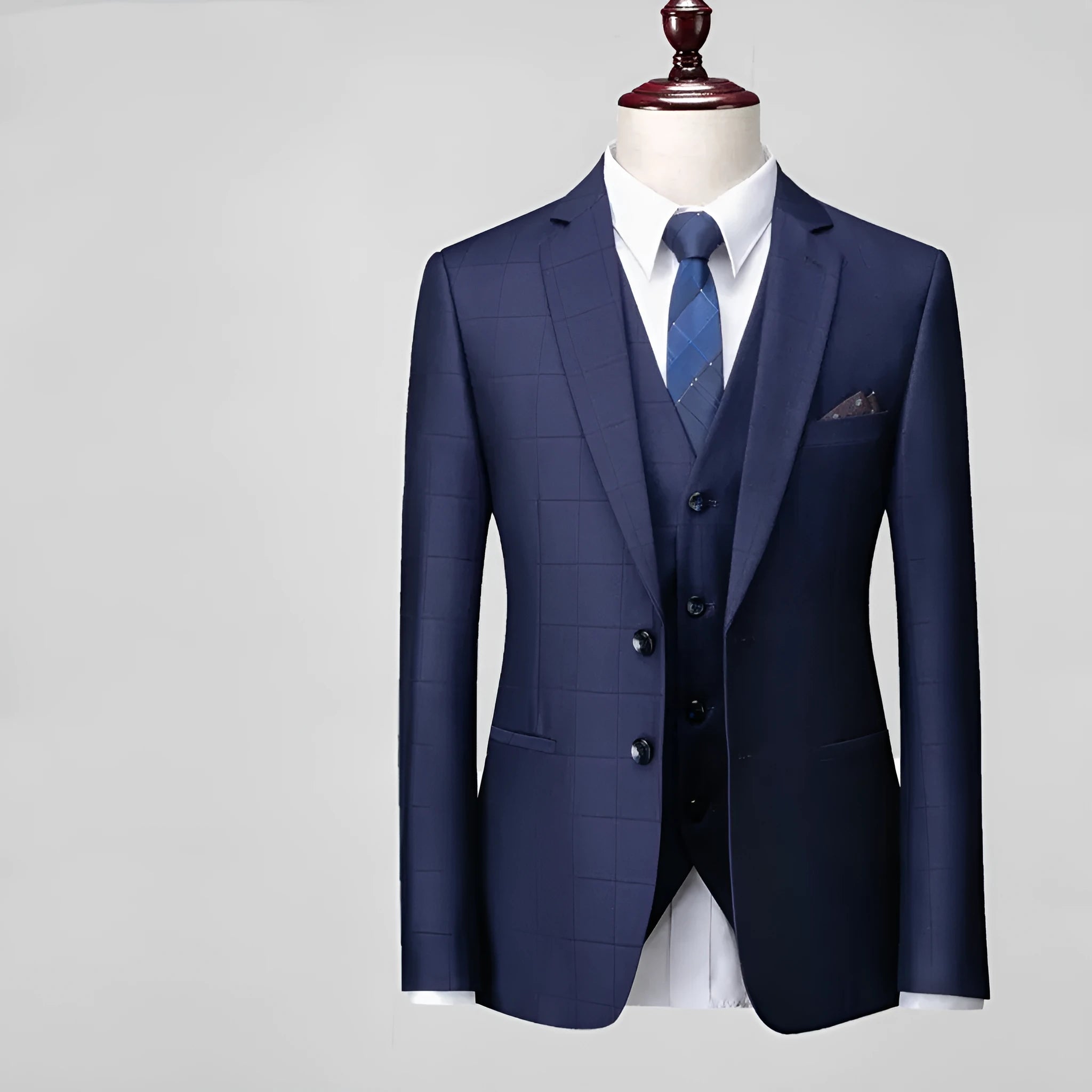 Men's navy blue plaid slim fit three-piece suit with jacket, vest and trousers on hanger