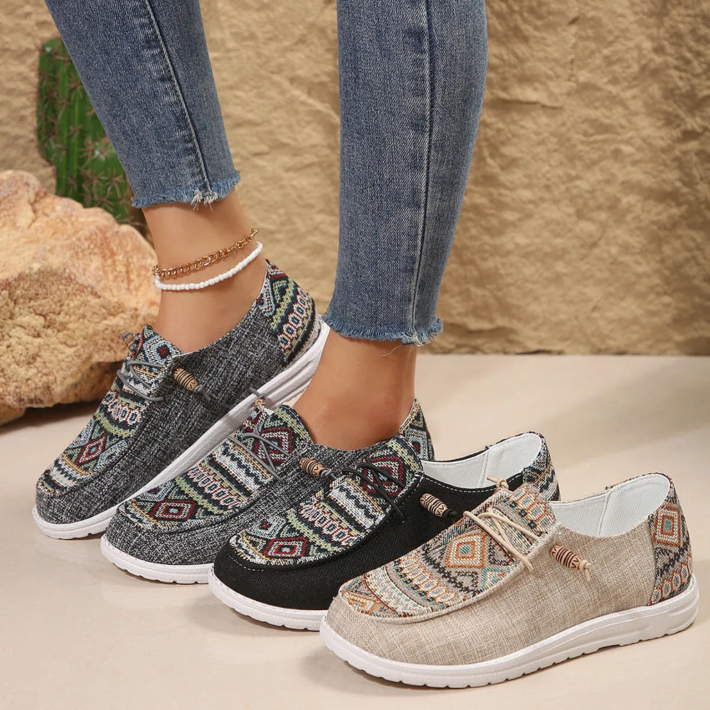 Women's black round toe low-top flat shoes with a rubber sole on a white background