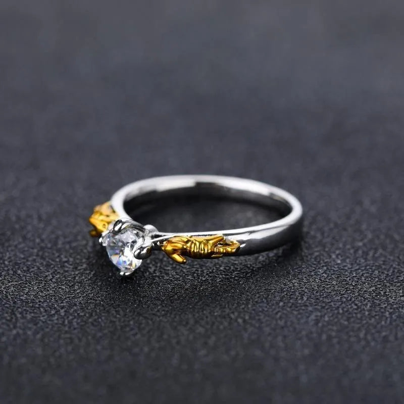 Close-up of a black gold finished copper ring with a detailed 1.5cm tall crown model on a person's finger.