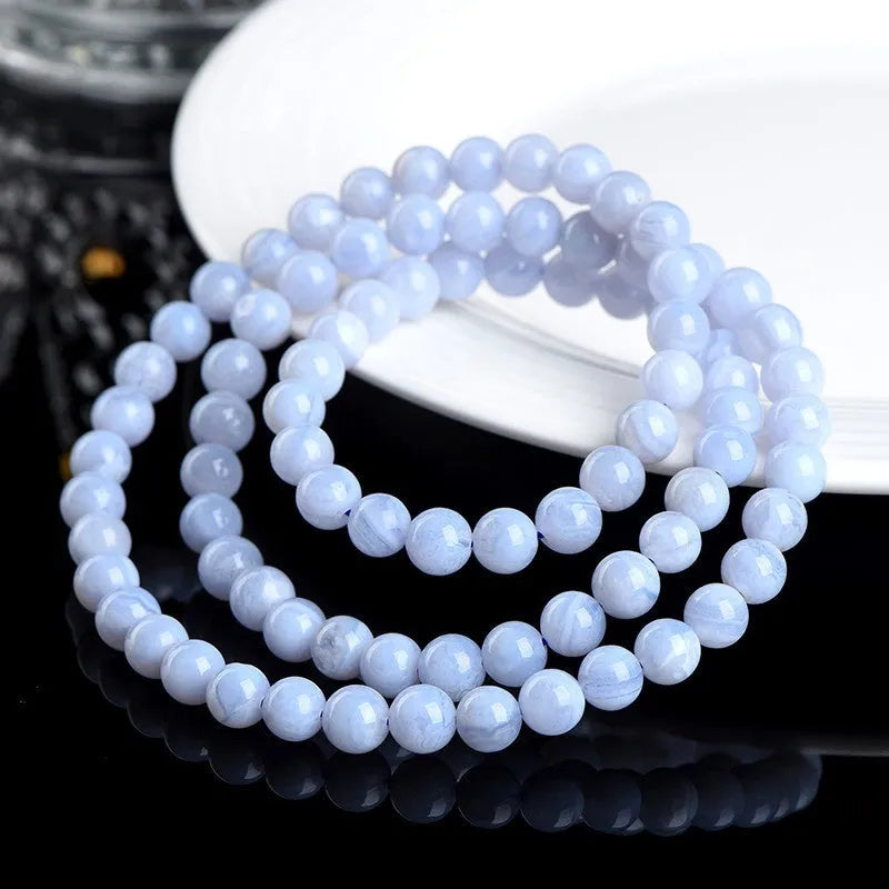 Blue agate bracelet with Ruyi symbol and scattered beads measuring 6-6.8mm.