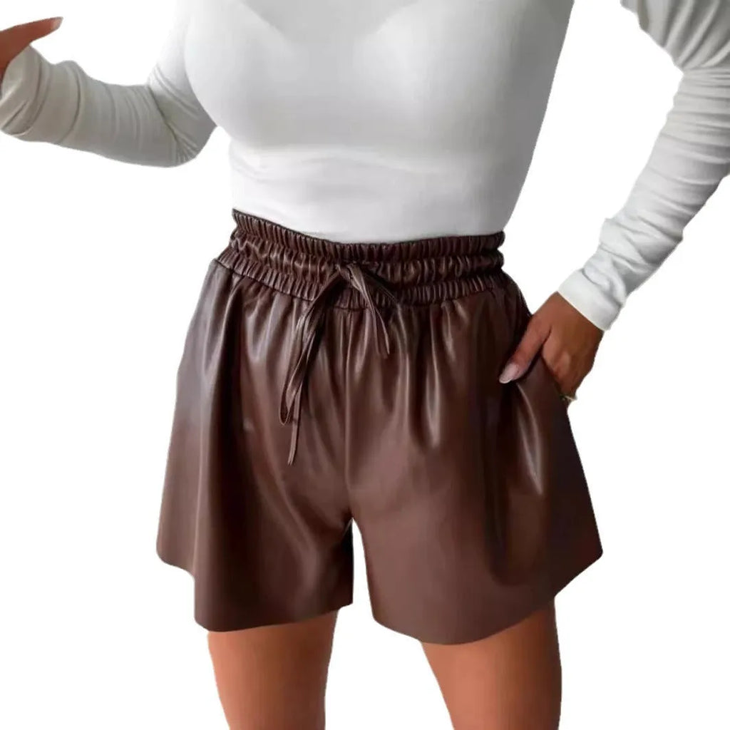 Black women's wide-leg shorts with lace-up drawstring detail on PU leather and straight-leg silhouette.