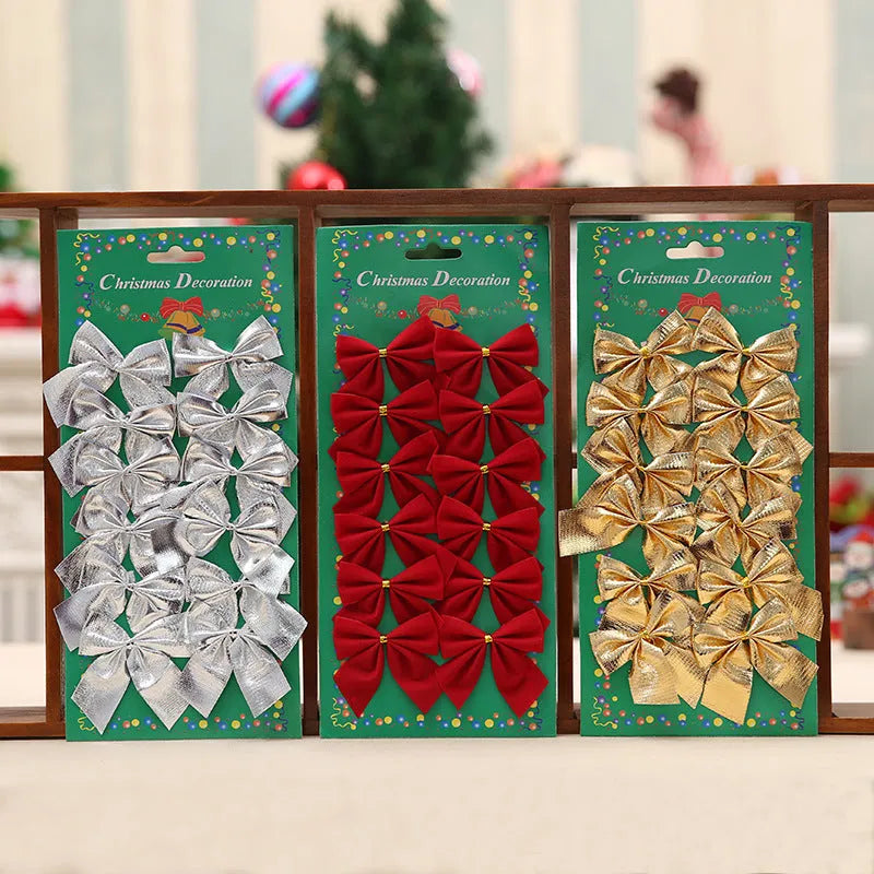 Red, gold, red gold, and silver 5 cm polyester Christmas bow ornaments on a green tree branch.