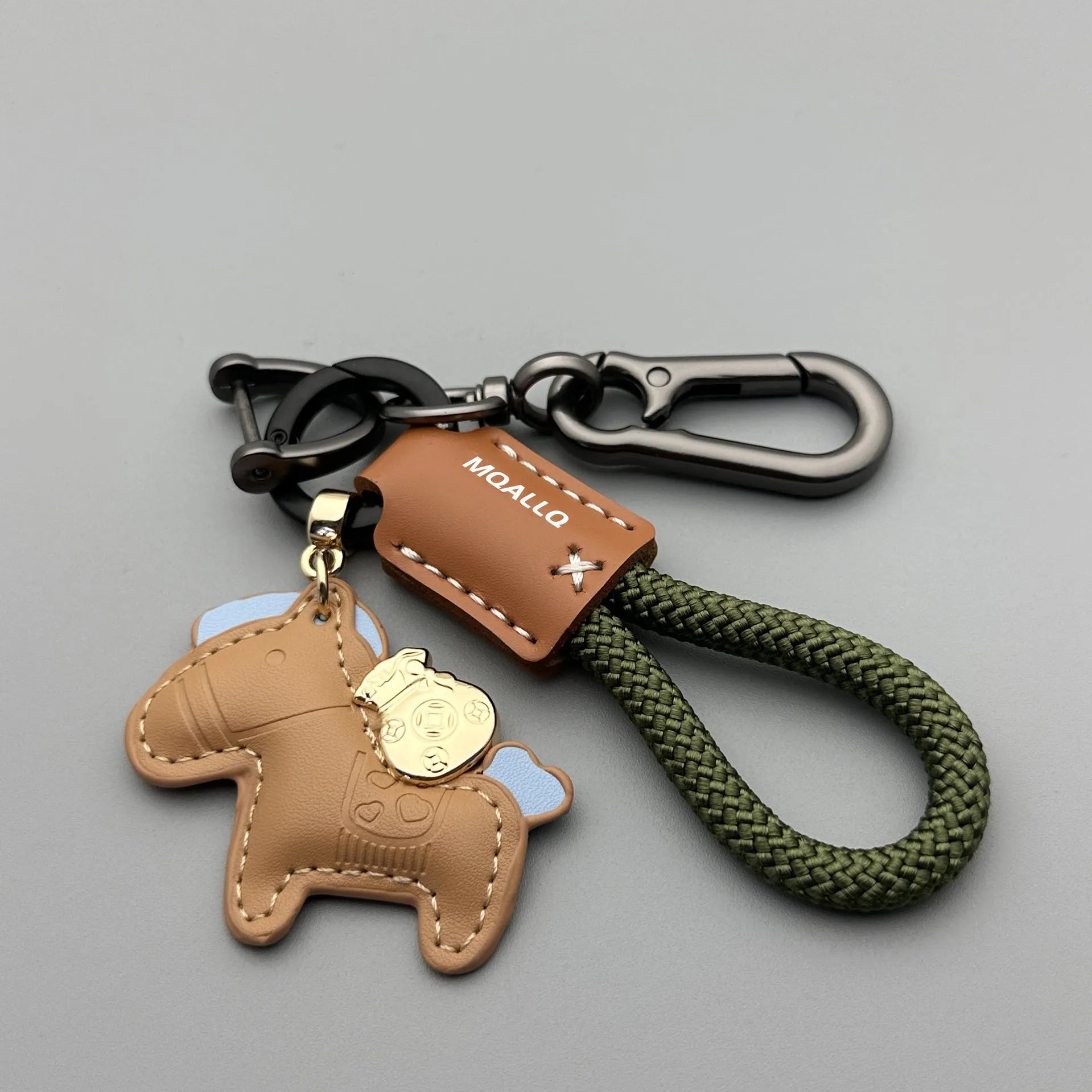 Handmade brown cowhide leather key ring with a zinc alloy pendant charm on a green flannel rope.
